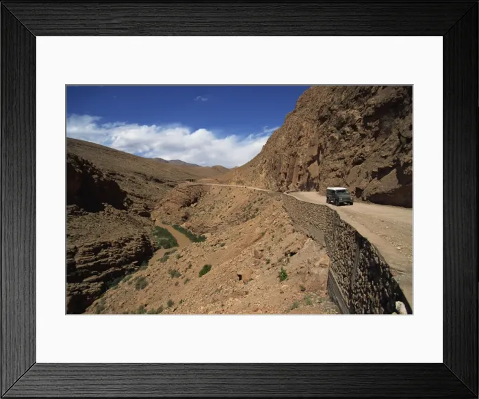 Framed Print : Four-wheel drive vehicle on a road through the Atlas Mountains Framed Print : Four-wheel drive vehicle on a road through the Atlas Mountains
