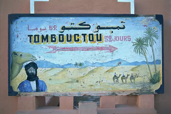Painted road sign pointing in the direction of Tombouctou (Timbuktu)