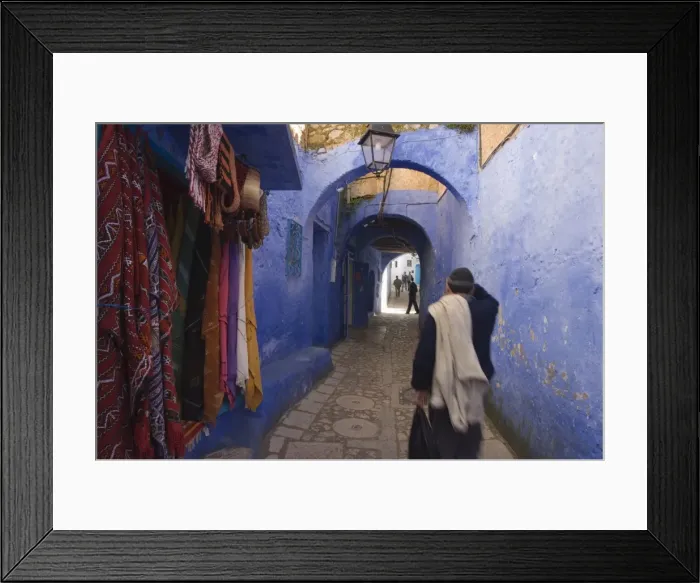 Framed Print : Man walking through pastel coloured streets of Chefchaouen Framed Print : Man walking through pastel coloured streets of Chefchaouen