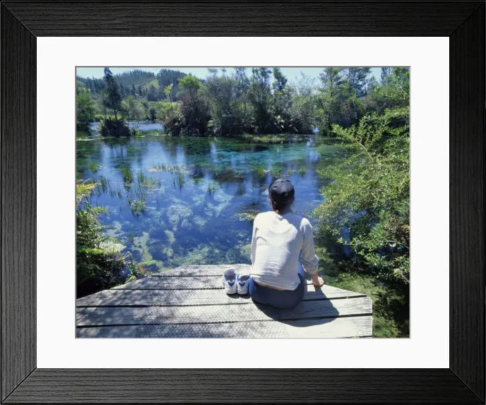 Framed Print : A tourist sitting on the edge of Pupu springs Framed Print : A tourist sitting on the edge of Pupu springs