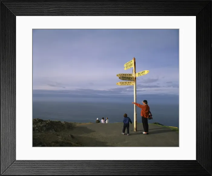Framed Print : Visitors by the sign at Cape Reinga on the coast of Northland Framed Print : Visitors by the sign at Cape Reinga on the coast of Northland