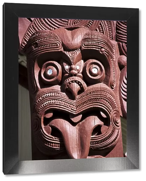Maori wooden carving with tongue sticking out