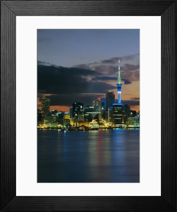 Framed Print : Evening view of city skyline across harbour Framed Print : Evening view of city skyline across harbour