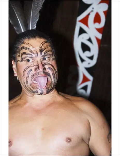 Local Maori man with traditional Moko face tattoo painting