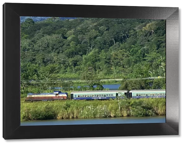 Passenger train on the railway beside the Panama Canal