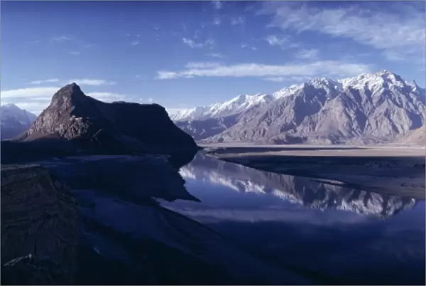 Panorama of mountains reflected in the water of the Indus River