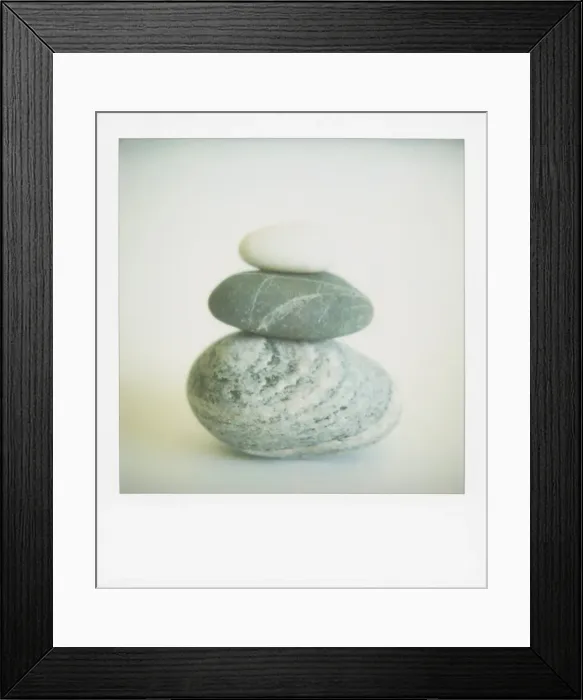 Framed Print : Polaroid of three sea-worn pebbles piled up against a white background Framed Print : Polaroid of three sea-worn pebbles piled up against a white background