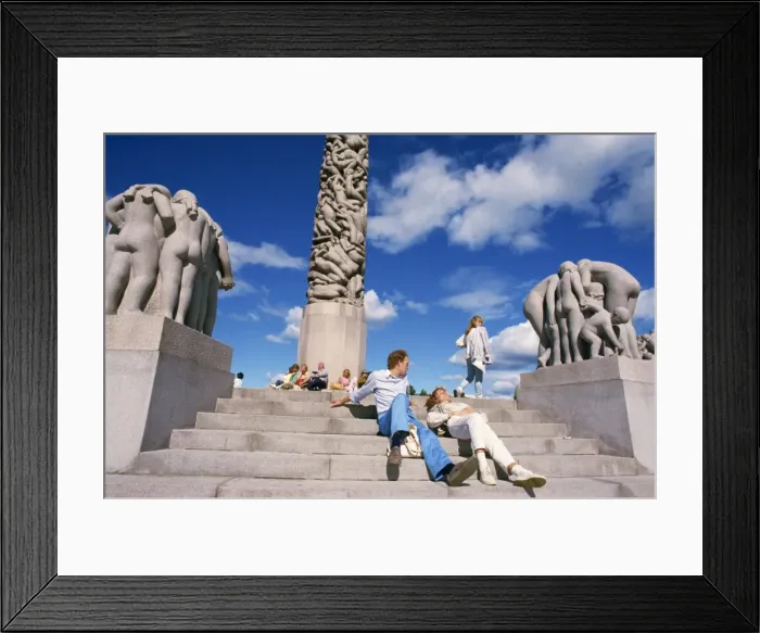Framed Print : People relaxing on steps before sculptures on the central Framed Print : People relaxing on steps before sculptures on the central