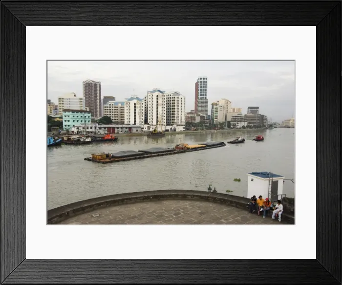Framed Print : Barge on River Pasig with city skyline behind Framed Print : Barge on River Pasig with city skyline behind