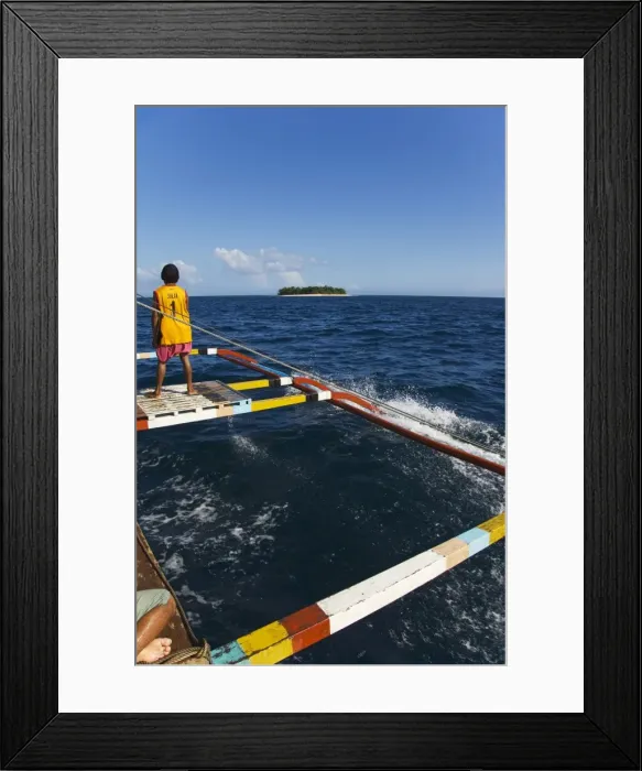 Framed Print : Shiphand on catamaran passing small desert island Framed Print : Shiphand on catamaran passing small desert island