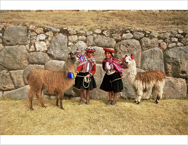 Local women and llamas in front of Inca ruins