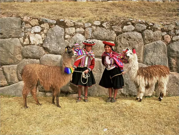 Local women and llamas in front of Inca ruins