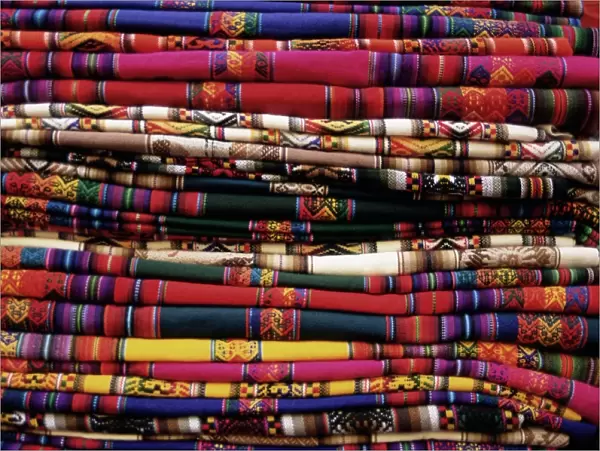 Detail of a pile of colourful ponchos