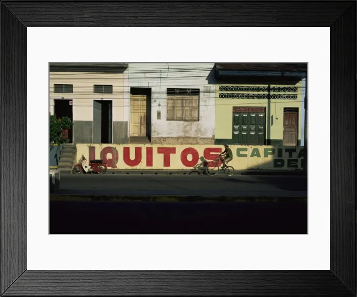 Framed Print : Bicycle cruises past homes Framed Print : Bicycle cruises past homes