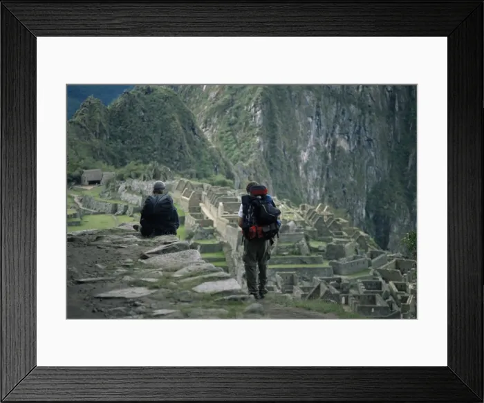 Framed Print : Backpackers look at the Inca ruins at Machu Picchu Framed Print : Backpackers look at the Inca ruins at Machu Picchu