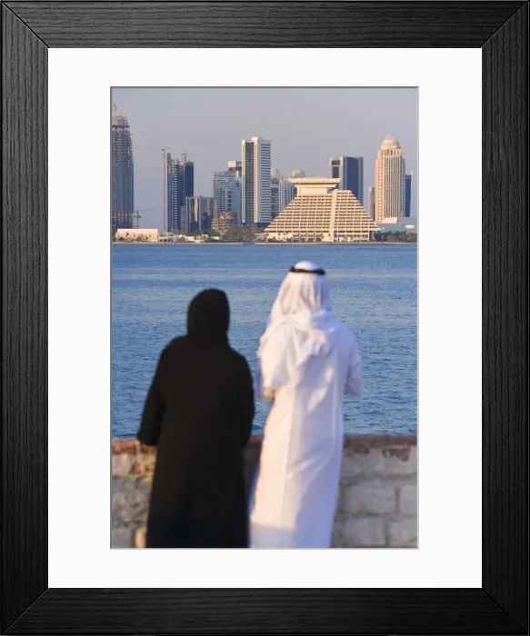 Framed Print : Man and woman in traditional dress looking across Doha Framed Print : Man and woman in traditional dress looking across Doha