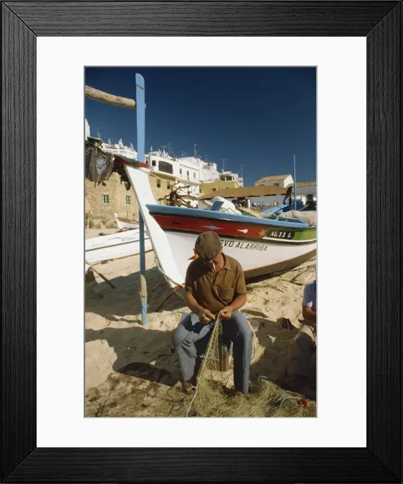 Framed Print : Fisherman fixing nets on beach Framed Print : Fisherman fixing nets on beach