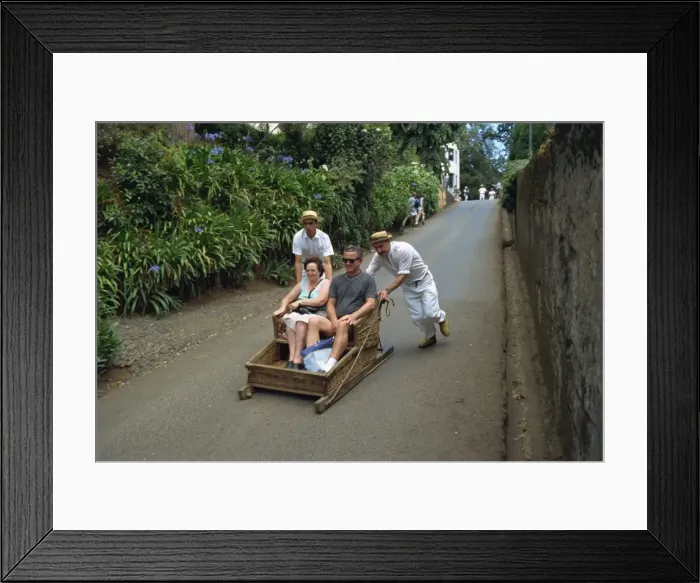 Framed Print : Tourists on toboggan riding down the hill at Monte Framed Print : Tourists on toboggan riding down the hill at Monte
