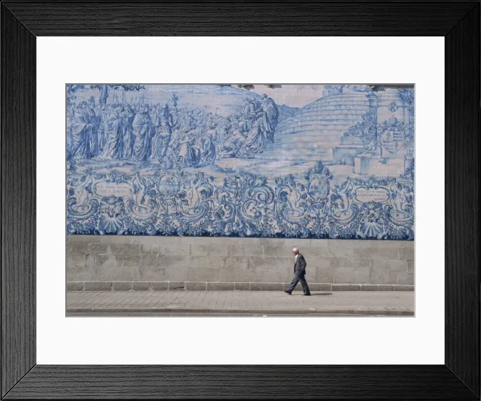 Framed Print : Man walks by the azulejo tile panel of the Carmo church in Oporto Framed Print : Man walks by the azulejo tile panel of the Carmo church in Oporto