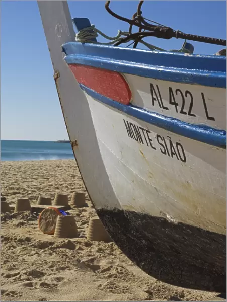 Traditional fishing boat and sand castles