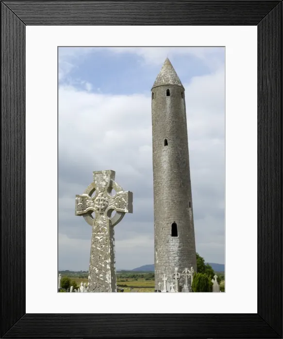 Framed Print : Kilmacdaugh Round Tower and Celtic style cross Framed Print : Kilmacdaugh Round Tower and Celtic style cross