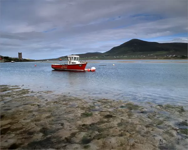 Red boat in Achill Sound at low tide