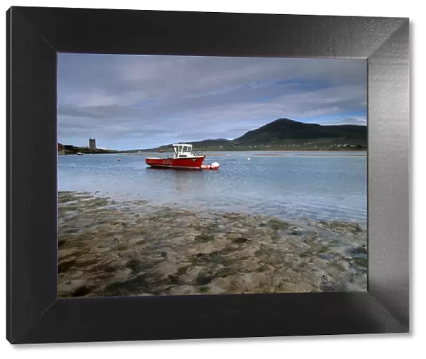 Red boat in Achill Sound at low tide