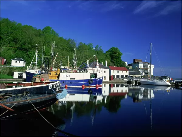 Tranquil scene of boats reflected in still water on the Crinan Canal