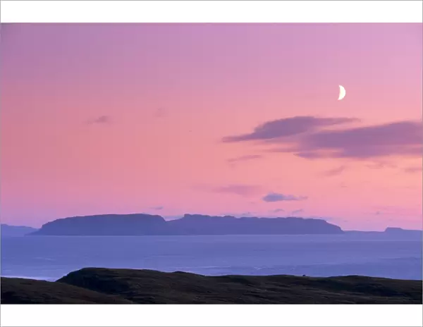 Sunset and half moon over Eigg island