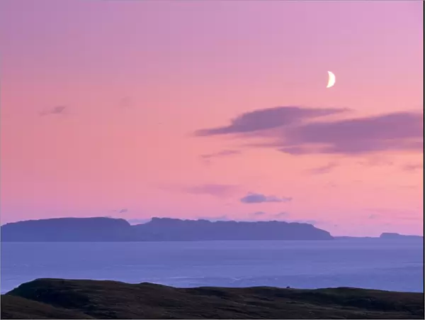 Sunset and half moon over Eigg island