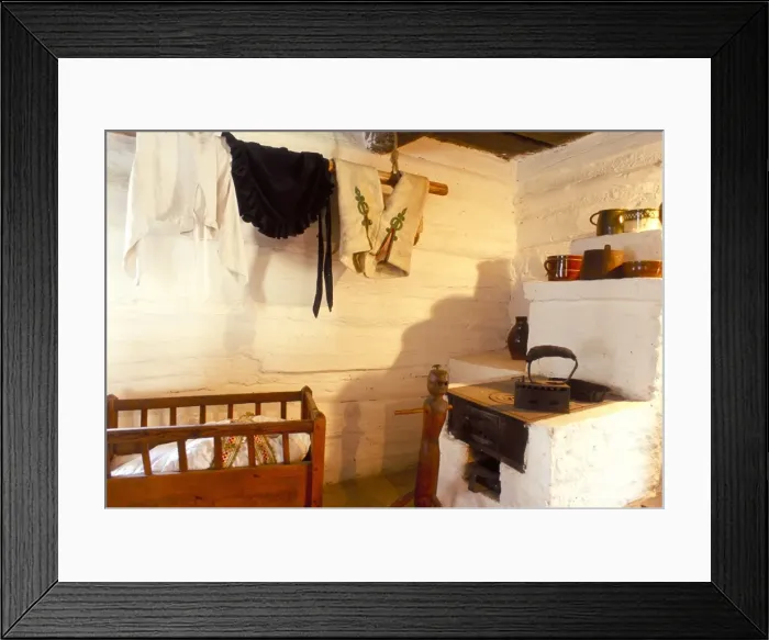 Framed Print : Stove and cot in living room of traditional house Framed Print : Stove and cot in living room of traditional house