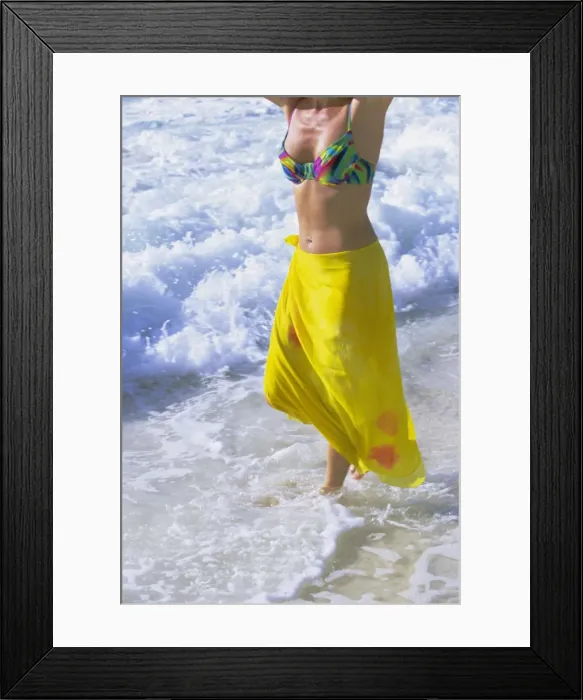 Framed Print : Woman standing in the surf