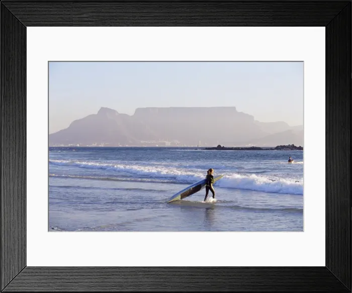 Framed Print : Young woman surfer enters the water of the Atlantic Framed Print : Young woman surfer enters the water of the Atlantic