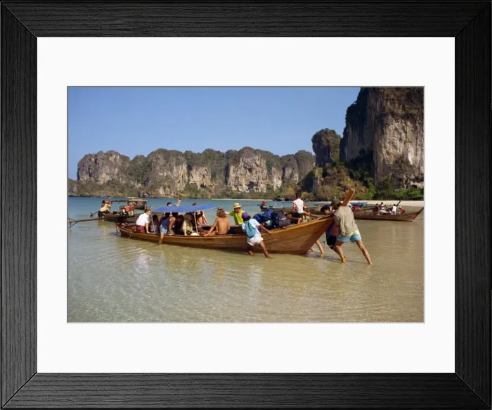 Framed Print : Launching a long tail boat full of backpackers from Framed Print : Launching a long tail boat full of backpackers from