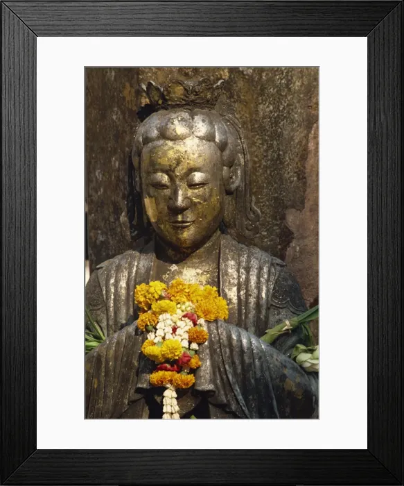 Framed Print : Detail of statue with offering of marigold flowers Framed Print : Detail of statue with offering of marigold flowers