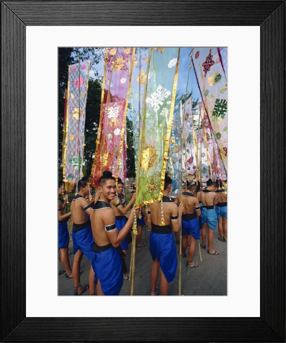 Framed Print : Portrait of a smiling man in a parade of colourful Framed Print : Portrait of a smiling man in a parade of colourful