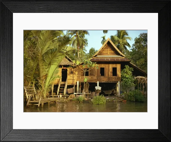 Framed Print : A traditional Thai house on stilts above the river in Bangkok Framed Print : A traditional Thai house on stilts above the river in Bangkok
