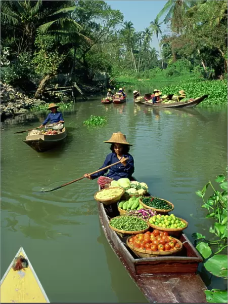 Women in canoes on way to floating market
