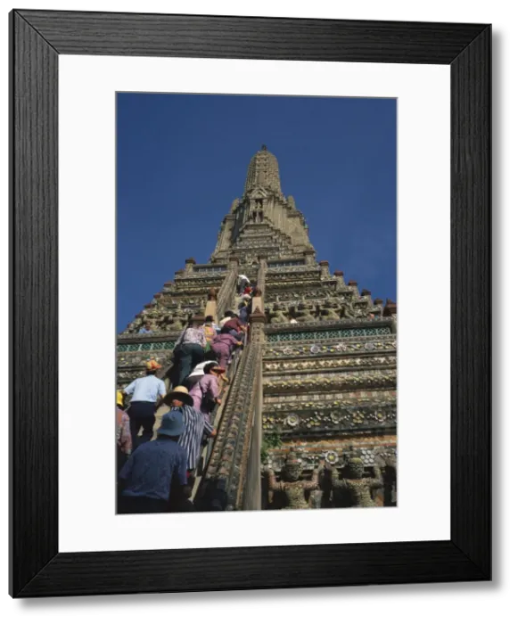 Framed Print : Tourists climb the steps of Wat Arun (Temple of the Dawn) Framed Print : Tourists climb the steps of Wat Arun (Temple of the Dawn)