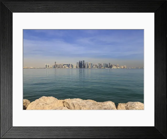 Framed Print : Modern city skyline of West Bay, across the calm turquoise waters of Doha Bay Framed Print : Modern city skyline of West Bay, across the calm turquoise waters of Doha Bay