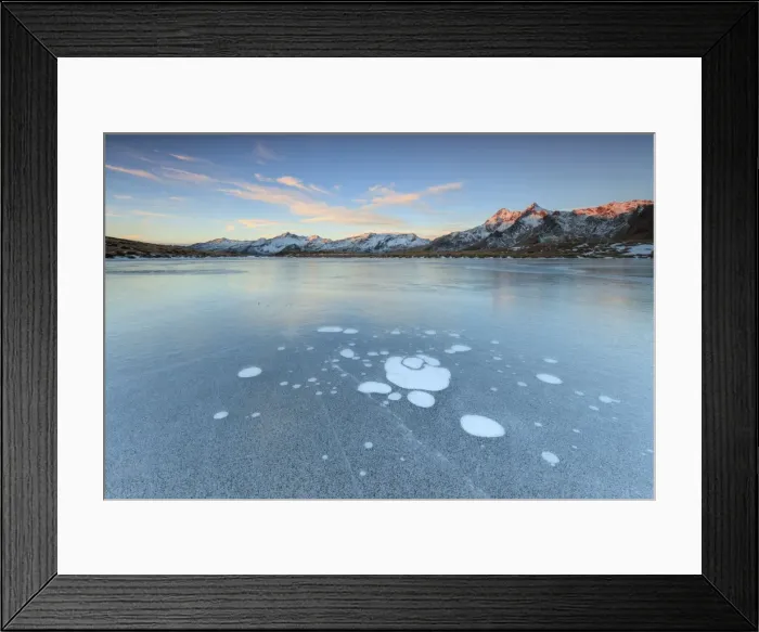 Framed Print : Ice bubbles on the frozen surface of Andossi Lake at sunrise, Spluga Valley, Valtellina Framed Print : Ice bubbles on the frozen surface of Andossi Lake at sunrise, Spluga Valley, Valtellina