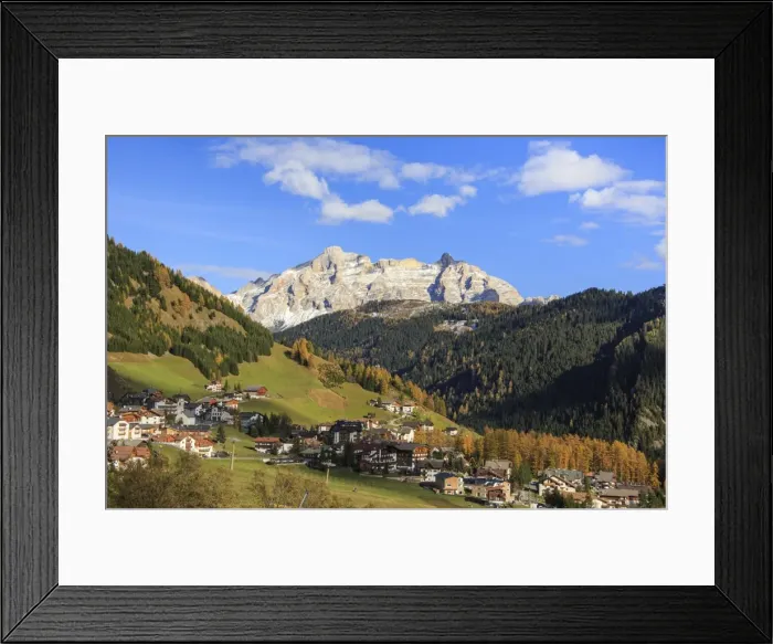 Framed Print : Colourful woods frame the village and the high peaks in autumn, Gardena Pass, South Tyrol Framed Print : Colourful woods frame the village and the high peaks in autumn, Gardena Pass, South Tyrol