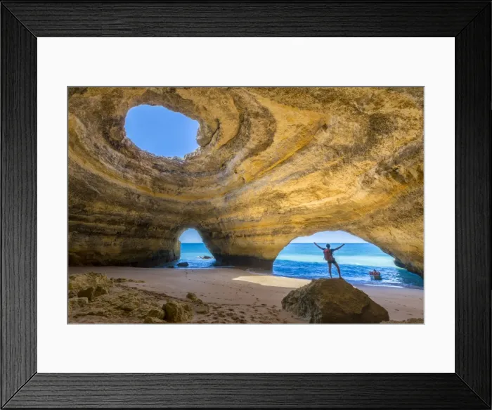 Framed Print : A tourist inside the sea caves of Benagil admires the clear waters of the Atlantic Ocean Framed Print : A tourist inside the sea caves of Benagil admires the clear waters of the Atlantic Ocean