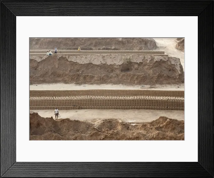 Framed Print : Brick workers amongst hand made bricks laid out on the ground to dry before baking Framed Print : Brick workers amongst hand made bricks laid out on the ground to dry before baking
