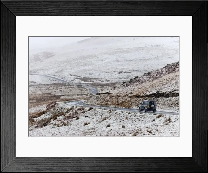 Framed Print : A four wheel drive vehicle negotiates a road through a wintry landscape in the Elan Framed Print : A four wheel drive vehicle negotiates a road through a wintry landscape in the Elan