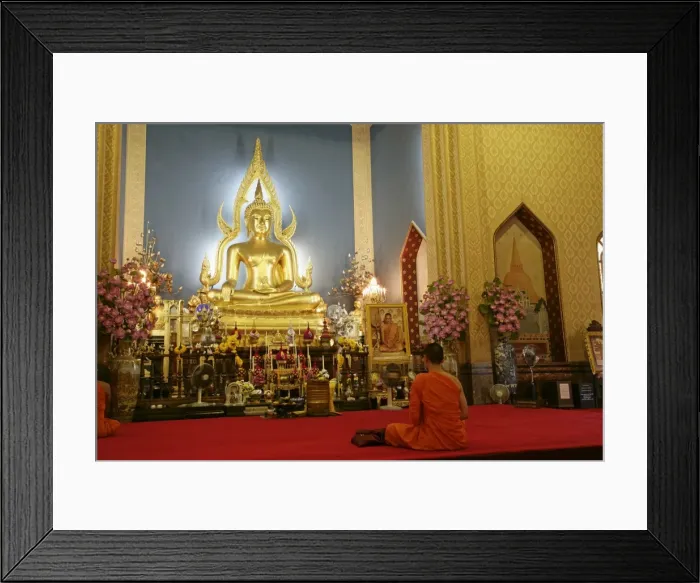 Framed Print : Monk praying and giant golden statue of the Buddha Framed Print : Monk praying and giant golden statue of the Buddha