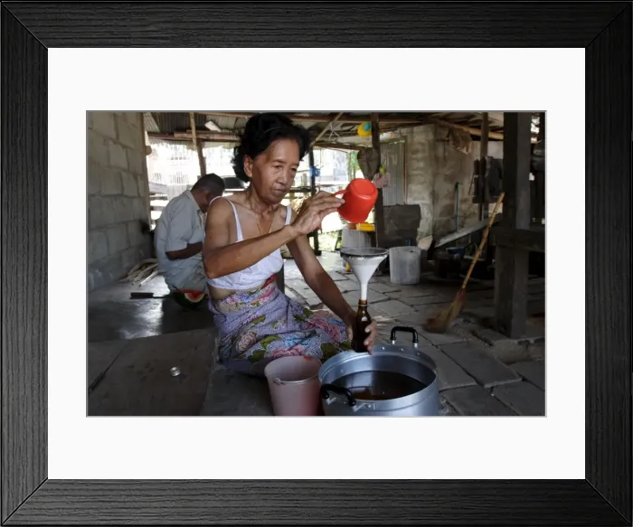 Framed Print : Bottling coconut oil to sell Framed Print : Bottling coconut oil to sell