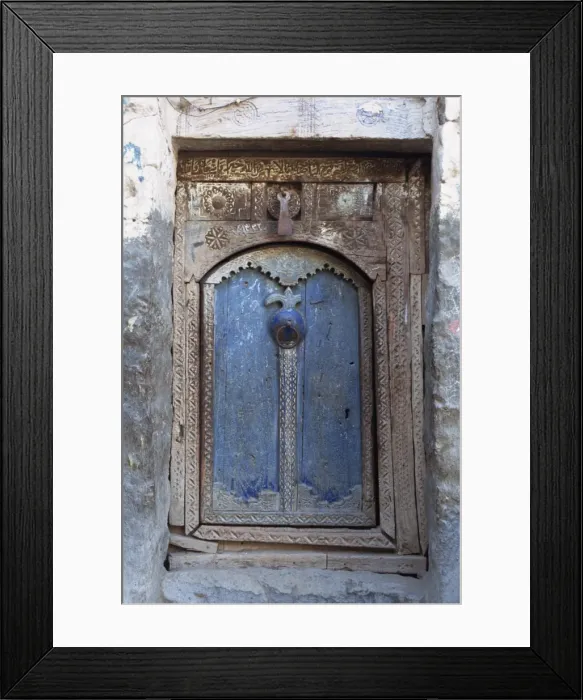 Framed Print : Close-up of a blue door in a carved wood frame in Framed Print : Close-up of a blue door in a carved wood frame in