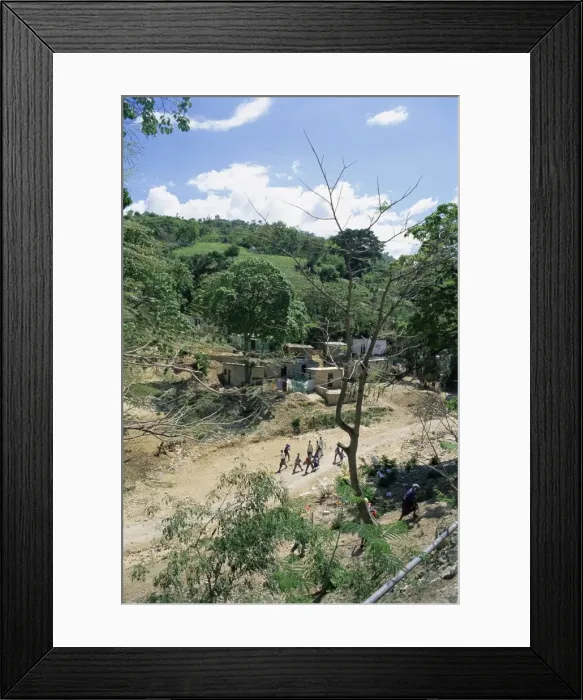 Framed Print : Houses and people walking in dry river bed caused by erosion Framed Print : Houses and people walking in dry river bed caused by erosion