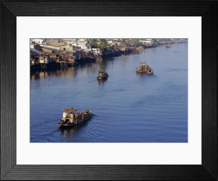 Framed Print : Riverside homes and boats on the Saigon River Framed Print : Riverside homes and boats on the Saigon River